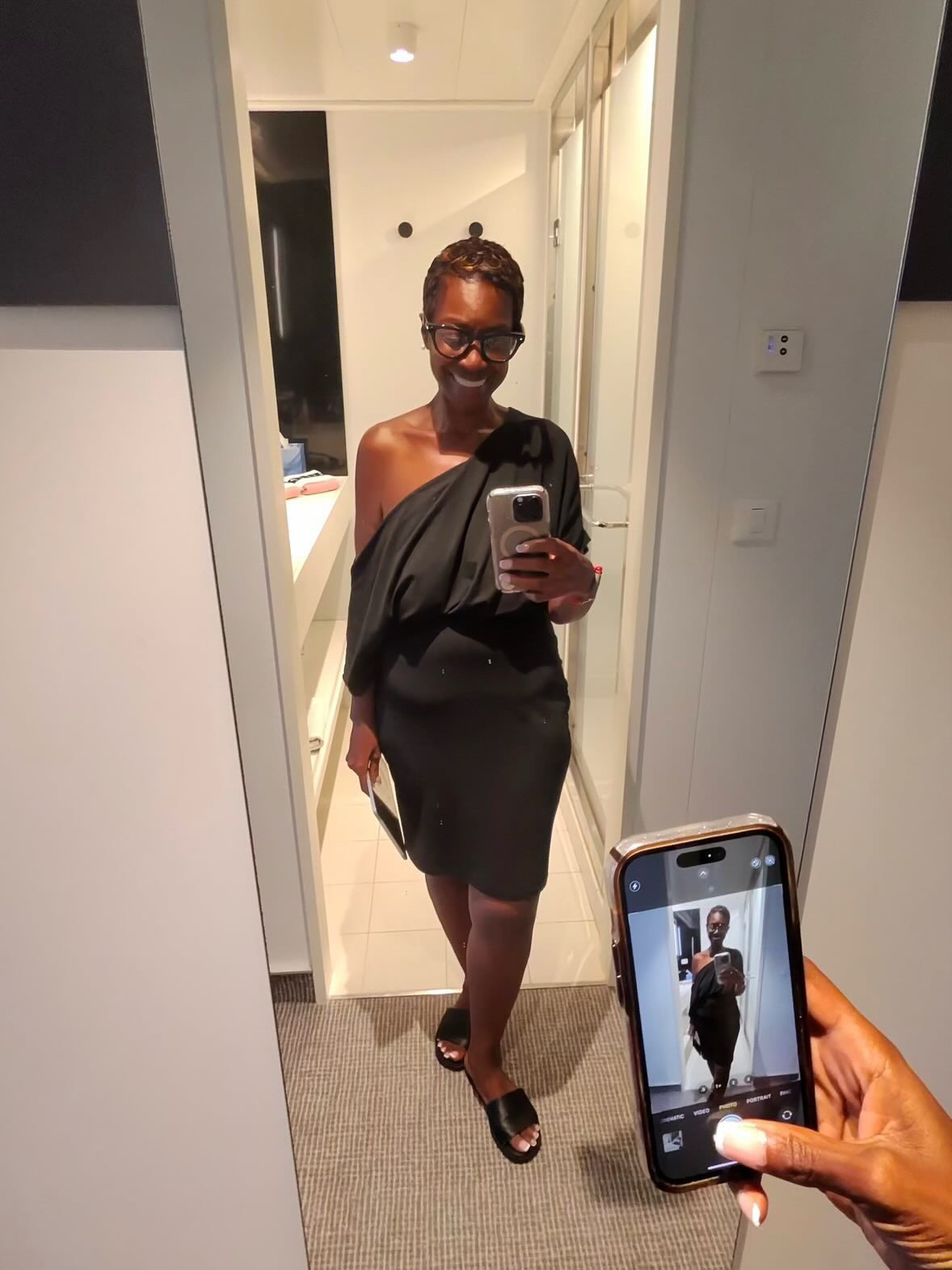 Arliee in a black dress, cabin mirror