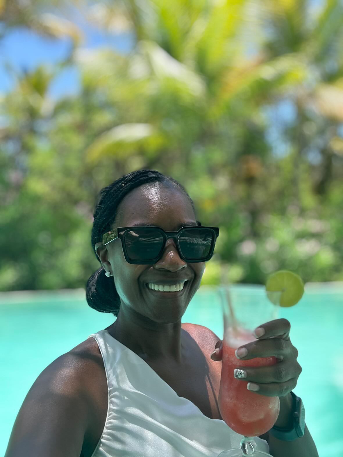 Arliee poolside with a tropical cocktail